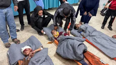 Palestinian children wounded in an Israeli strike on a house lie wrapped in blankets on stretchers as casualties receive treatment at a hospital in Rafah in the southern Gaza Strip, on Friday. REUTERS