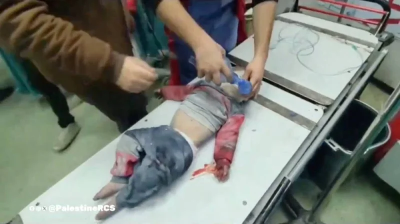 A member of the Palestine Red Crescent Society rushes a Palestinian child casualty inside a hospital, in a location given as Khan Younis, Gaza in this screengrab obtained from a video released on Saturday. Palestine Red Crescent Society/Handout via REUTERS