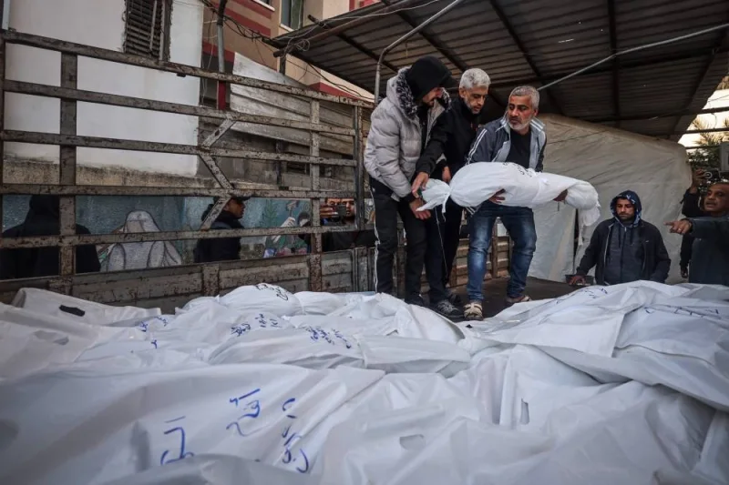 The shrouded bodies of people killed in Rafah during Israeli bombardment on the southern Gaza strip, are placed on a truck for burial outside Al-Najar hospital on Friday. AFP