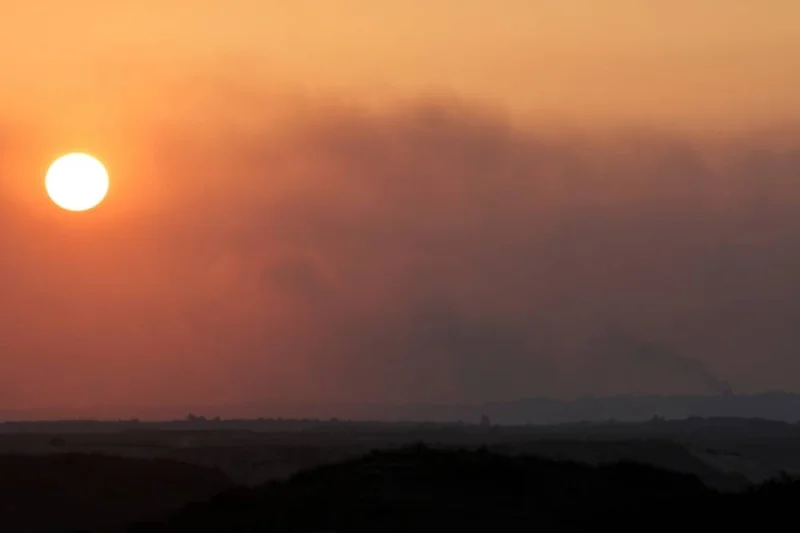 Smoke rises over Gaza at sunset as seen from southern Israel, on Sunday. REUTERS