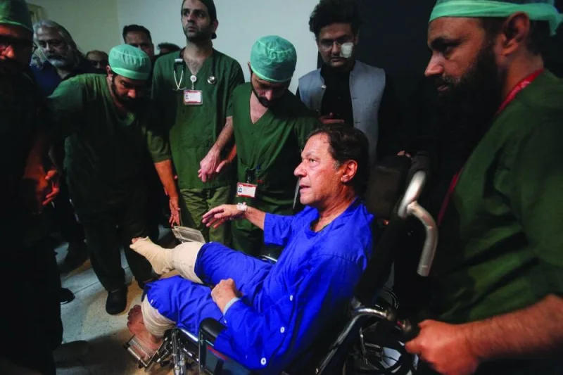 
Former Pakistan prime minister Imran Khan sits in a wheelchair at the Shaukat Khanum Memorial Cancer Hospital & Research Centre in Lahore on November 4, 2022 after sustaining bullet injuries in an assassination attempt during a long march in Wazirabad. (Reuters) 