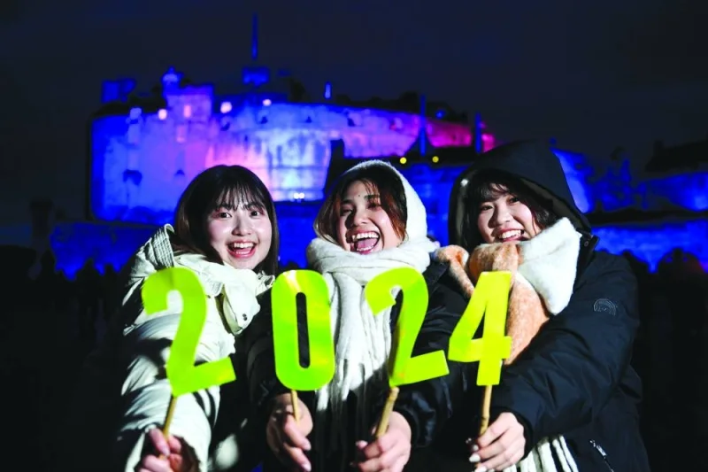 Japanese students visiting Edinburgh enjoy themselves during the Hogmanay street party celebrations in the UK.