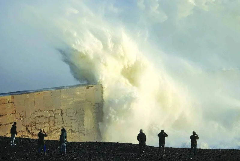 
People watch as waves crash against the breakwater in Newhaven as Storm Henk brought strong winds and heavy rain across much of southern England. 