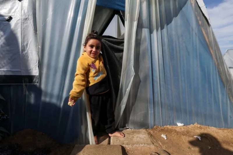 A displaced Palestinian girl, who fled her home due to Israeli strikes, shelters in a tent camp, in Rafah, southern Gaza Strip, on Wednesday. REUTERS
