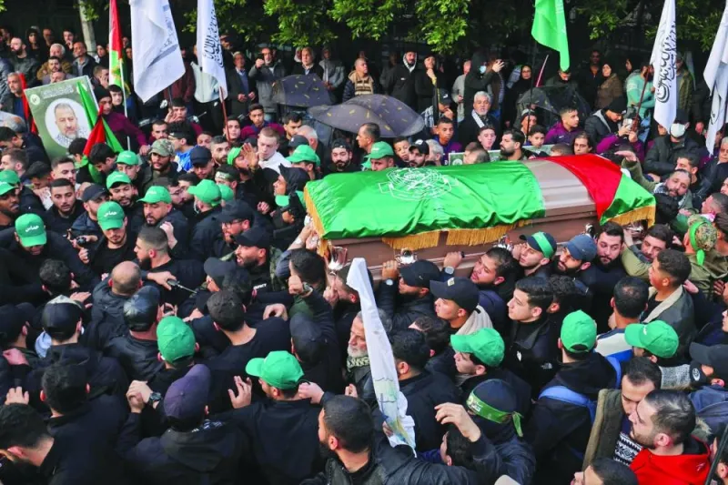 Mourners carry the coffin of Hamas leader Saleh al-Aruri during his funeral procession in Beirut yesterday.