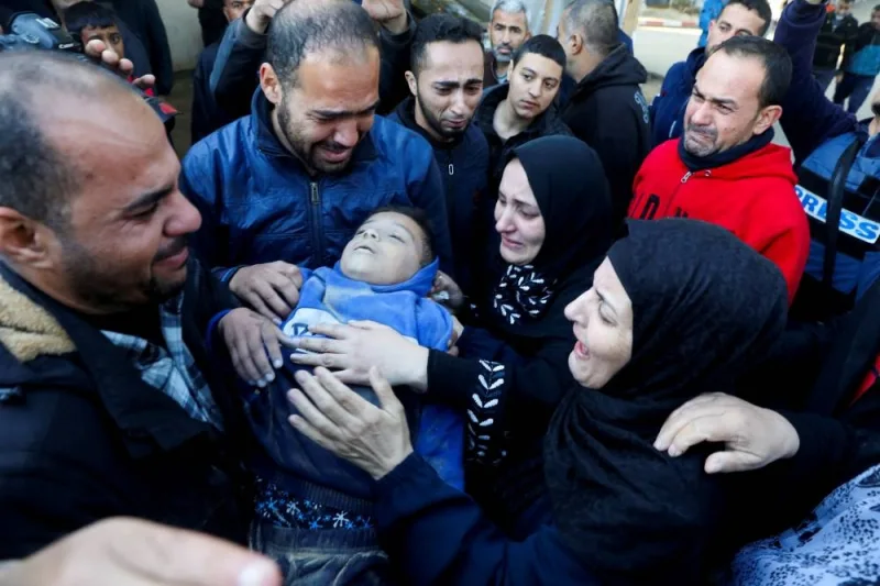 Palestinian journalist Mohammed Awad reacts as he carries the body of his nephew who was killed in an Israeli strike, at the European Hospital, in Khan Younis in the southern Gaza Strip on Saturday. REUTERS