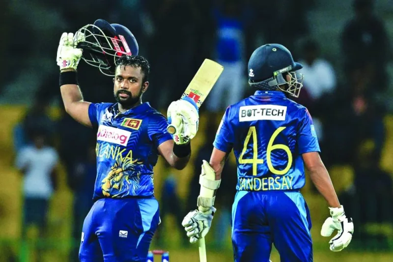 Sri Lanka’s Charith Asalanka (left) celebrates after scoring a century during the first ODI against Zimbabwe at the R. Premadasa Stadium in Colombo on Saturday. (AFP)