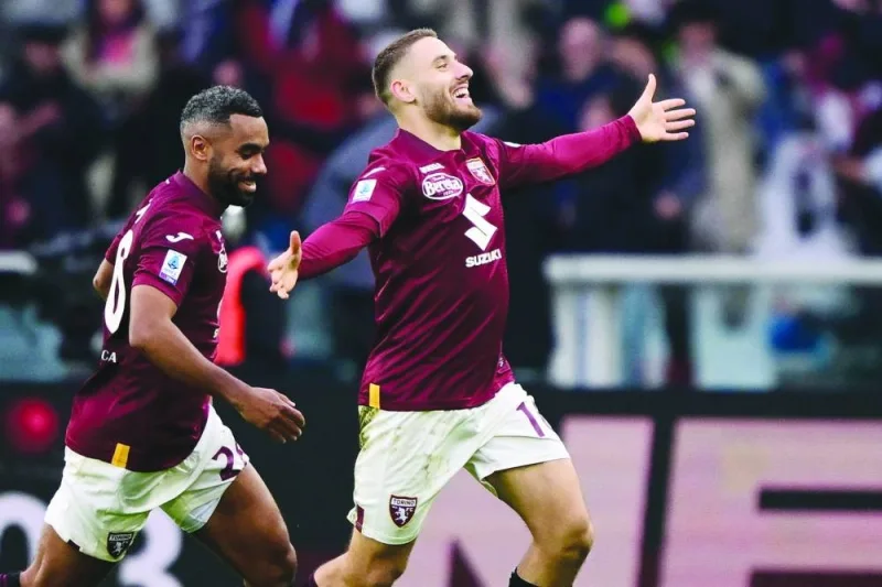 
Torino’s Croatian midfielder Nikola Vlasic (right) celebrates after scoring the second goal for his team during the Italian Serie A match against Napoli at the “Stadio Grande Torino” in Turin yesterday. (AFP) 