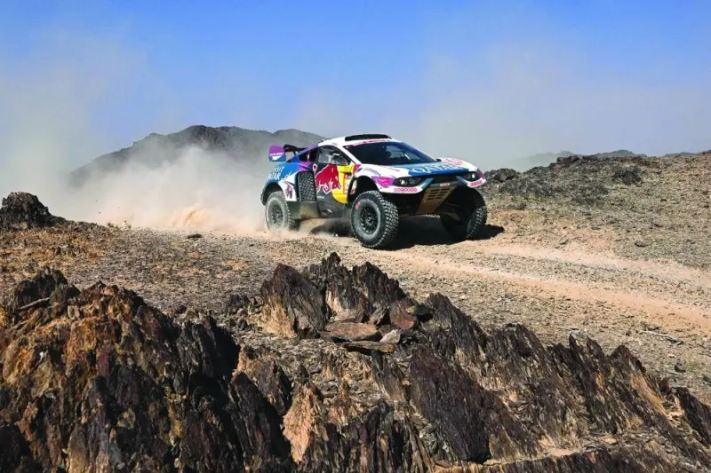 
Nasser Racing’s Qatari driver Nasser al-Attiyah and his French co-driver Mathieu Baumel steer their car during stage 2 of the Dakar Rally 2024, between Al Henakiyah and Al Duwadimi, Saudi Arabia, yesterday. Right: Team Audi Sport’s French driver Stephane Peterhansel and French co-driver Edouard Boulanger in action during stage 2 yesterday.  (AFP) 