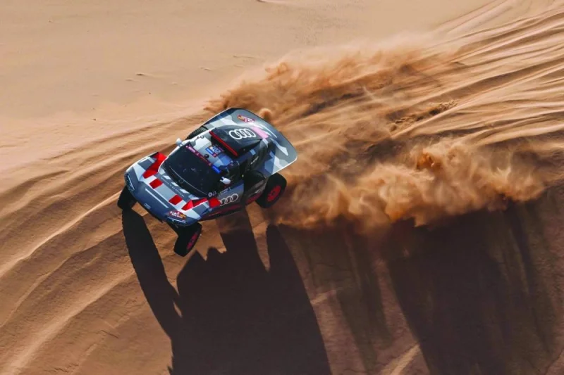 Team Audi Sport&#039;s French driver Stephane Peterhansel and French co-driver Edouard Boulanger steer their car during stage 2 between Al Henakiyah and Al Duwadimi, Saudi Arabia, yesterday as part of the Dakar Rally 2024. (AFP)