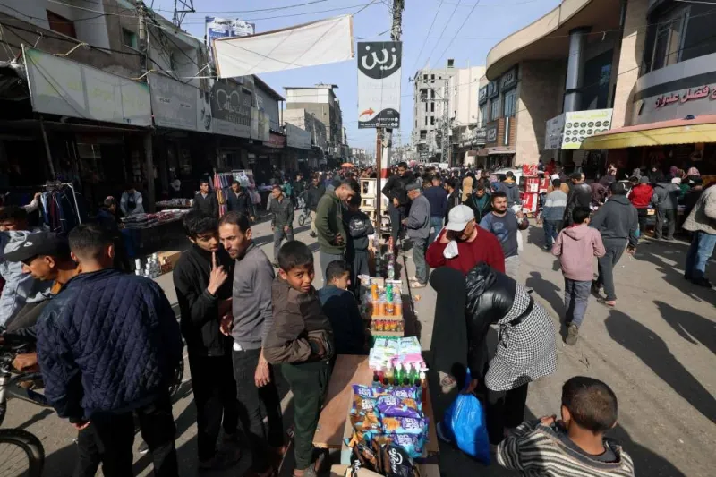 Palestinians shop at a market in Rafah refugee camp in the Gaza Strip on Monday. AFP