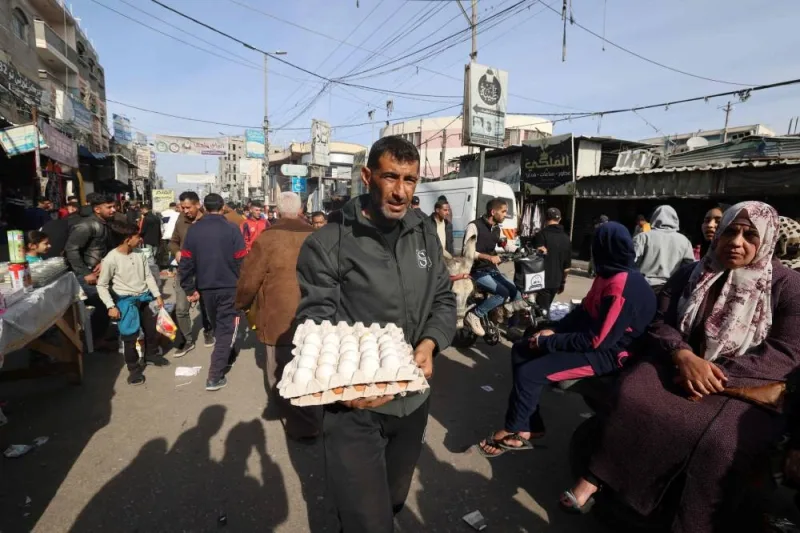 A Palestinian man carries eggs at a market in Rafah refugee camp in the Gaza Strip on Monday. AFP