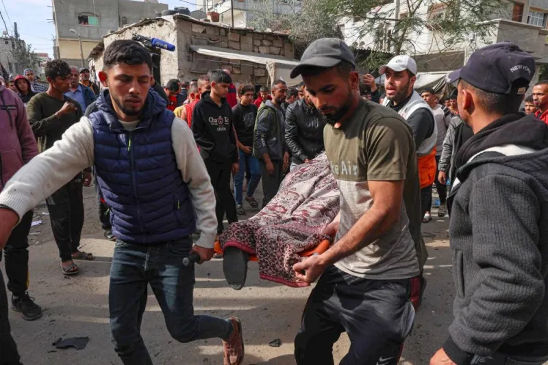 Palestinian men evacuate the body of a victim after a reported Israeli bombardment hit a car in Rafah in the southern Gaza Strip on Monday. AFP