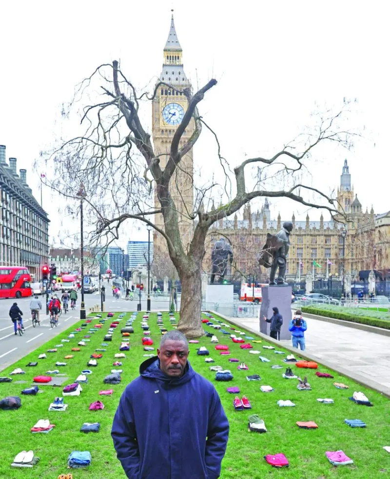 
British actor Idris Elba stands in front of a display of clothing representing individual victims as he highlights an anti-knife crime campaign, near the Houses of Parliament in London. 