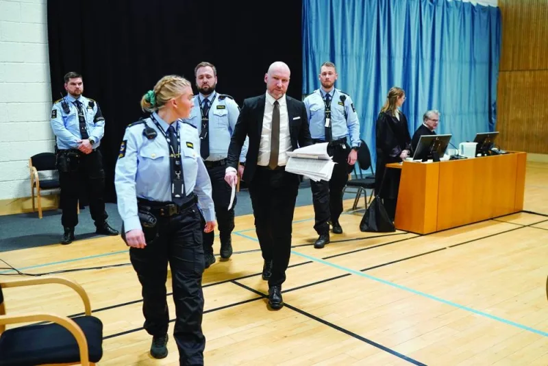 Anders Behring Breivik is accompanied by guards as he arrives at the courtroom to give his statement on day two of the trial, at Ringerike prison, in Tyristrand, Norway, on Tuesday. (Reuters)