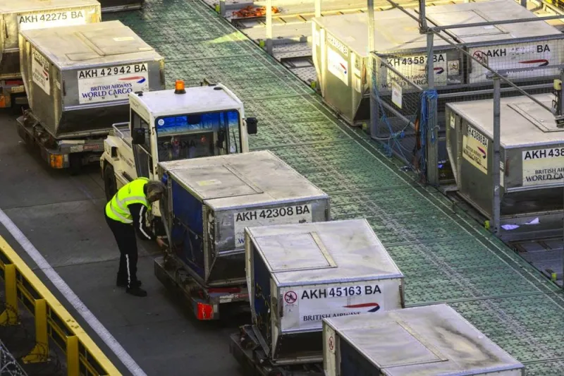 A cargo handler prepares air freight containers for a British Airways flight at Heathrow Airport in London. Air cargo is set for a positive 2024 with all regions expected to experience growth this year, according to the International Air Transport Association, the global body of airlines.