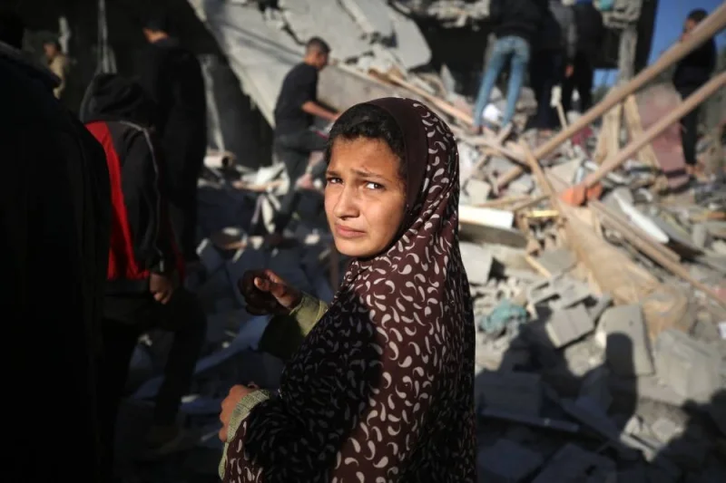 A Palestinian girl reacts to the rubble of a house in Deir el-Balah in the central Gaza Strip after an Israeli strike, on Wednesday. AFP