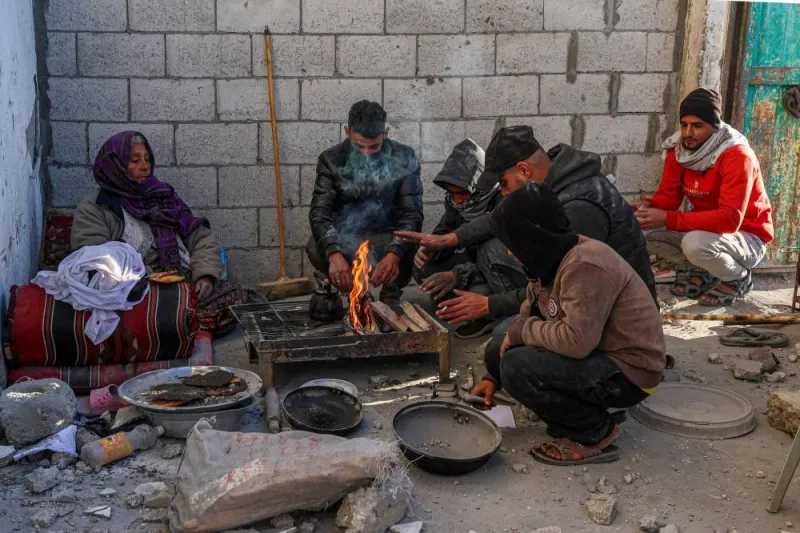 People prepare food in a damaged house following Israeli bombardment in Rafah in the southern Gaza Strip on Saturday. AFP 