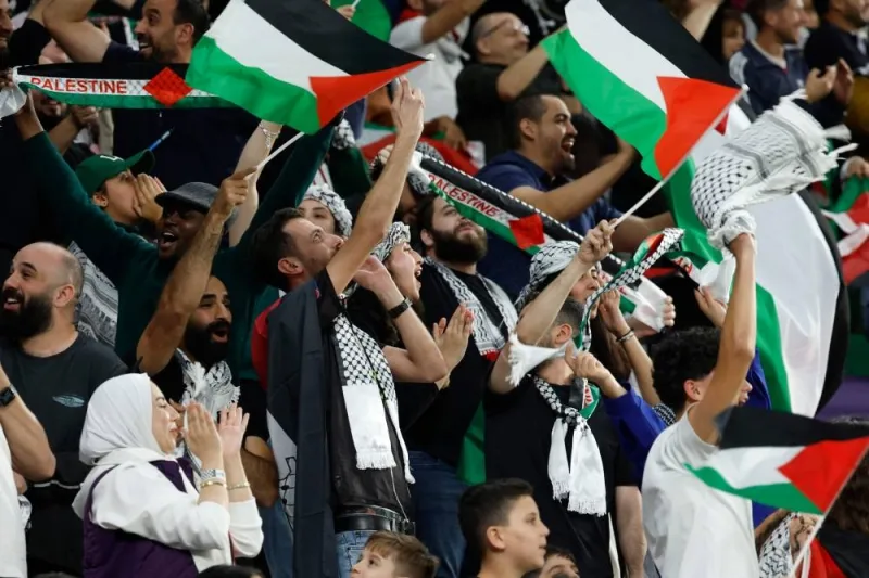 Palestine&#039;s supporters cheer for their team during the Qatar 2023 AFC Asian Cup Group C football match between Iran and Palestine at the Education City Stadium Sunday.