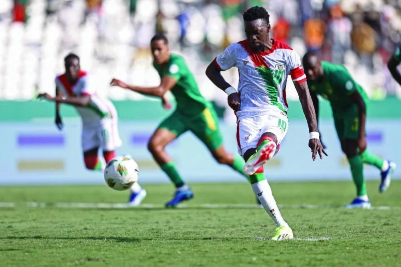 Burkina Faso’s forward Bertrand Traore shoots and scores his team’s first goal from a penalty kick during the Africa Cup of Nations 2024 Group D match against Mauritania at Stade de la Paix in Bouake on Tuesday. (AFP)