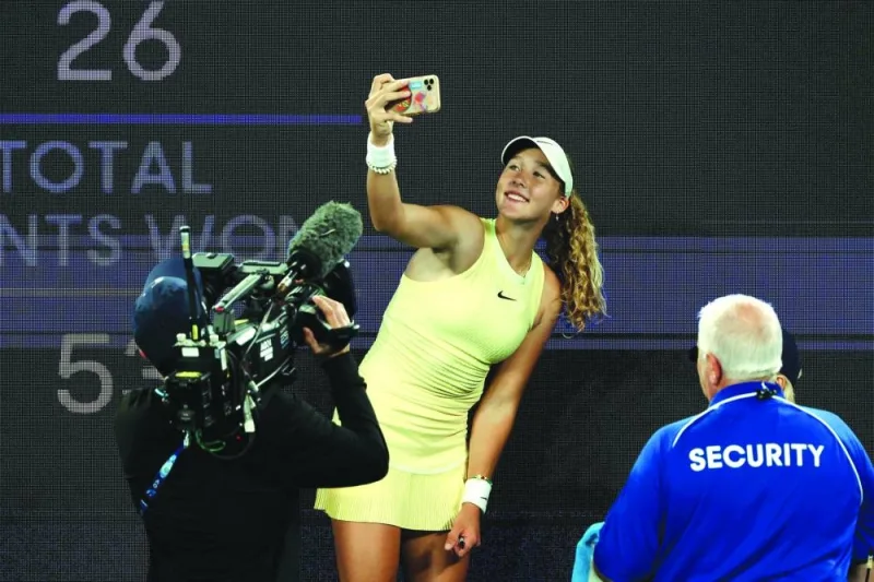  Right: Russia’s Mirra Andreeva takes selfies after beating Tunisia’s Ons Jabeur. (AFP)