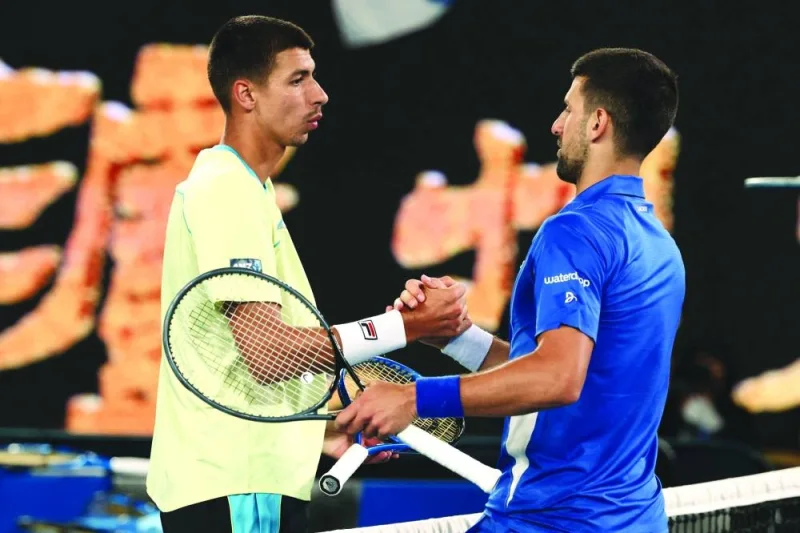 Serbia’s Novak Djokovic (right) shakes hands with Australia’s Alexei Popyrin after their singles match on day four of the Australian Open in Melbourne on Wednesday. (Reuters)