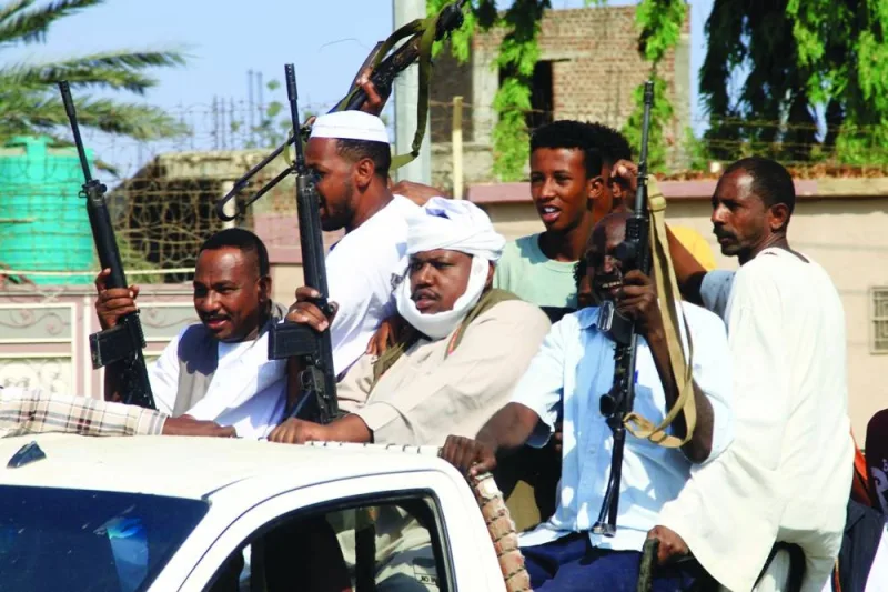
Members of the Sudanese armed popular resistance, which supports the army, raise their weapons on a pick up truck during a meeting with the city’s governor in Gedaref on Tuesday amid the ongoing conflict in Sudan between the army and paramilitaries. (AFP) 