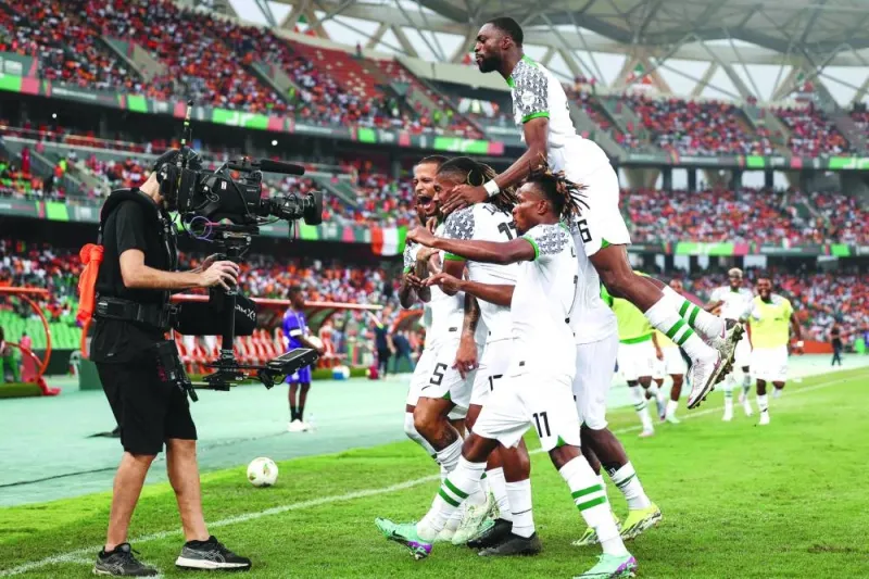 Nigeria’s defender (5) William Troost-Ekong (centre) celebrates with teammates after shooting a penalty and scoring his team’s first goal during the Africa Cup of Nations (CAN) 2024 group A match against Ivory Coast at the Alassane Ouattara Olympic Stadium in Ebimpe, Abidjan, on Thursday. (AFP)