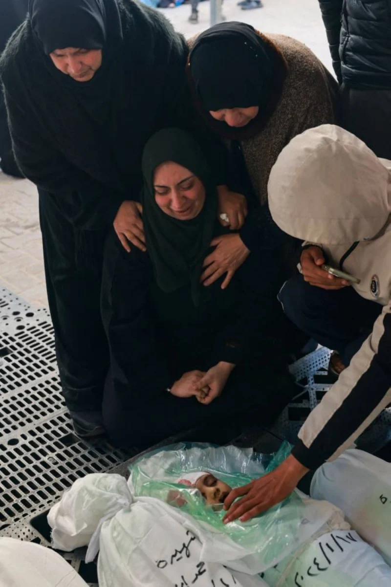 Relatives mourn over the shrouded body of Masa Shoman, who was killed during Israeli bombardment, outside Najjar hospital in Rafah, on the southern Gaza Strip, on Wednesday. AFP