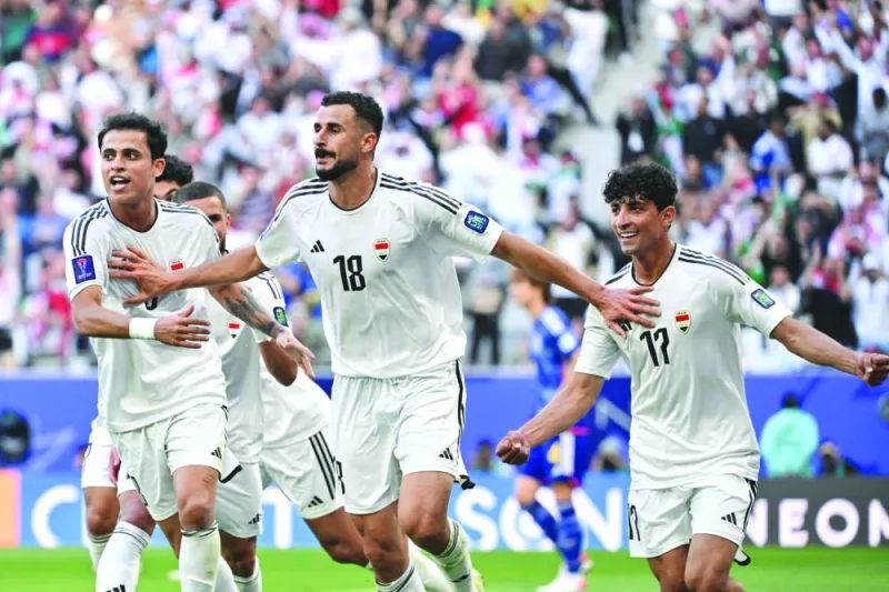 Iraq&#039;s forward (No.18) Aymen Hussein celebrates with teammates after scoring his team&#039;s second goal during the Qatar 2023 AFC Asian Cup Group D match against Japan at the Education City Stadium in Doha Friday. AFP