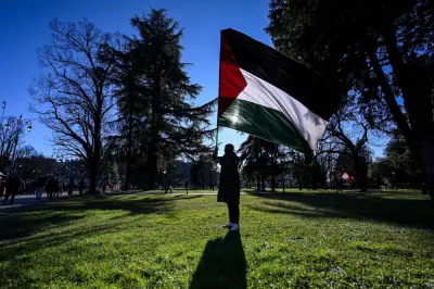 A demonstrator waves a Palestinian flag during a protest against the presence of an Israeli pavillion at Vicenzaoro, the largest show in Europe for the gold and jewellery industry, at Fiera Vicenza in Vicenza,  Saturday.