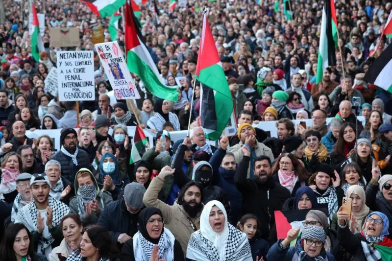 Protesters hold banners and wave flags during a rally in support of Gaza, in Barcelona Saturday
