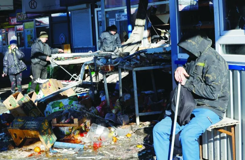 
People remove debris at a food market following a Ukrainian strike in Donetsk yesterday. 