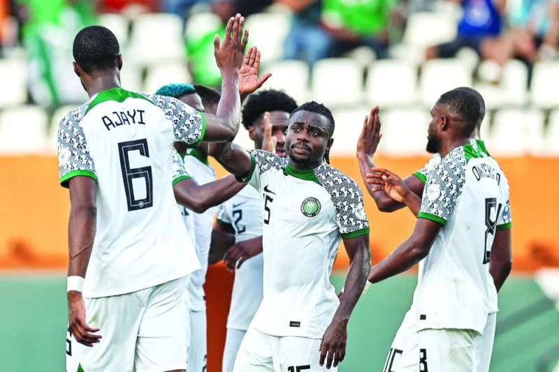 Nigeria’s forward (15) Moses Simon (centre) celebrates with teammates after Guinea-Bissau’s defender Opa Sangante (unseen) scored an 
own-goal during the Africa Cup of Nations 2024 Group A match at the Felix Houphouet-Boigny Stadium in Abidjan on Monday. (AFP)
