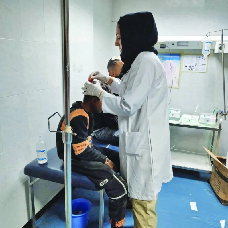 An injured Palestinian boy receives medical assistance at Al-Amal Hospital, in Khan Younis, Gaza Strip, Tuesday.