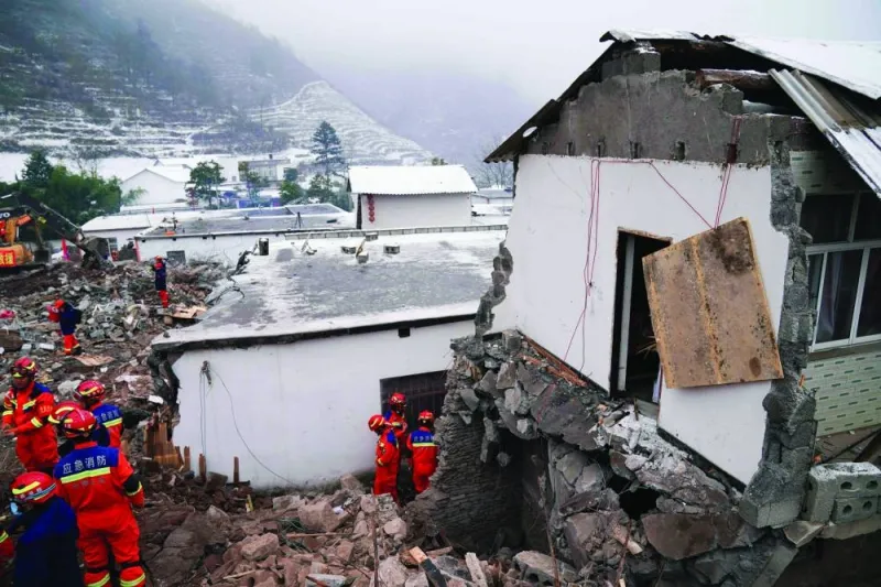 Rescue workers search for missing victims at a damaged house following a landslide in Liangshui village at Zhaotong, in southwestern China&#039;s Yunnan province. 