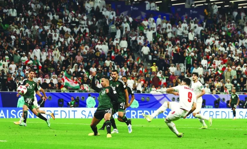 Iran’s Mehdi Taremi scores against the United Arab Emirates at the Education City Stadium on Tuesday. (Reuters)