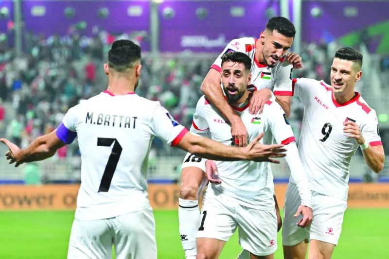 Palestine’s forward Oday Dabbagh (centre) celebrates with teammates after scoring against Hong Kong during the AFC Asian Cup Group C match at the Abdullah Bin Khalifa Stadium in Doha on Tuesday. (AFP)