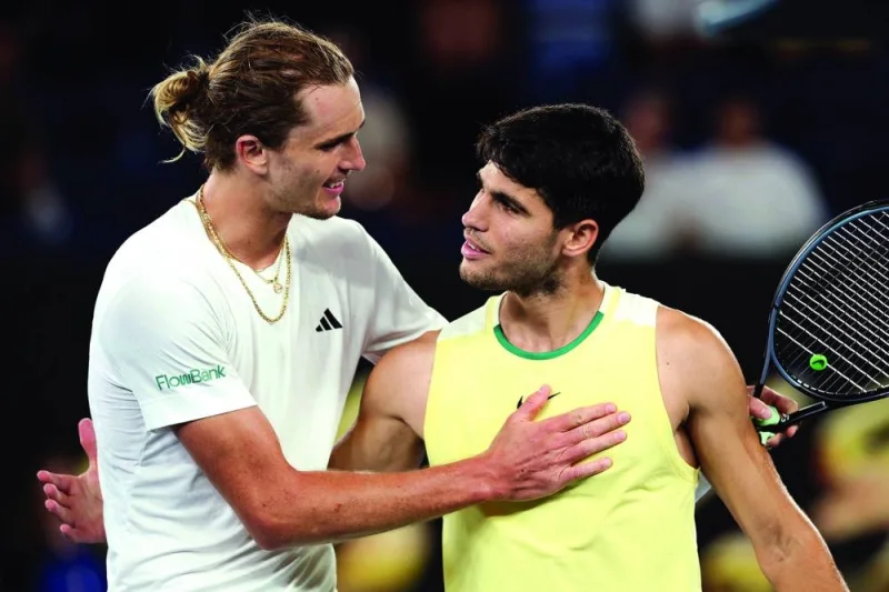 Germany’s Alexander Zverev (left) embraces Spain’s Carlos Alcaraz after their singles quarter-final on day 11 of the Australian Open in Melbourne on Wednesday. (AFP)