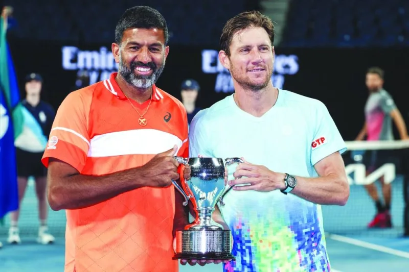 India’s Rohan Bopanna (left) and Australia’s Matthew Ebden celebrate with the trophy after victory against Italy’s Simone Bolelli and Andrea Vavassori during their men’s doubles final of the Australian Open in Melbourne on Saturday. (AFP)