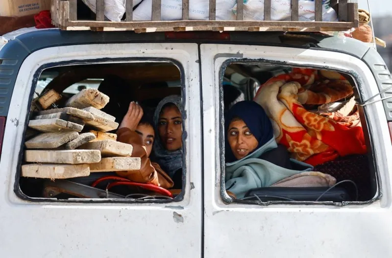 Palestinian women fleeing Khan Younis, due to the Israeli ground operation, move towards Rafah, in the southern Gaza Strip, on Sunday. REUTERS