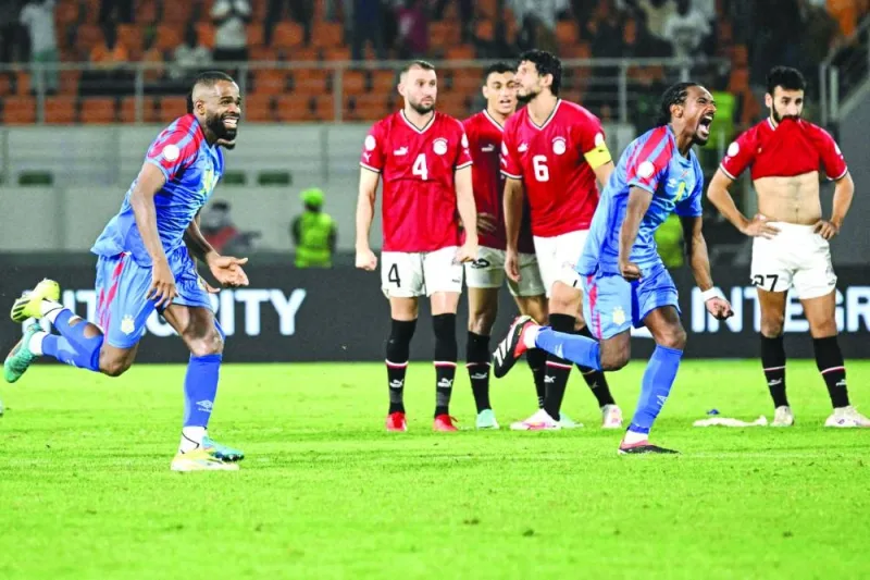 DR Congo’s Gedeon Kalulu (left) and Samuel Moutoussamy celebrate next to Egypt’s players after winning the the Africa Cup of Nations round of 16 match in San Pedro on Monday. (AFP)