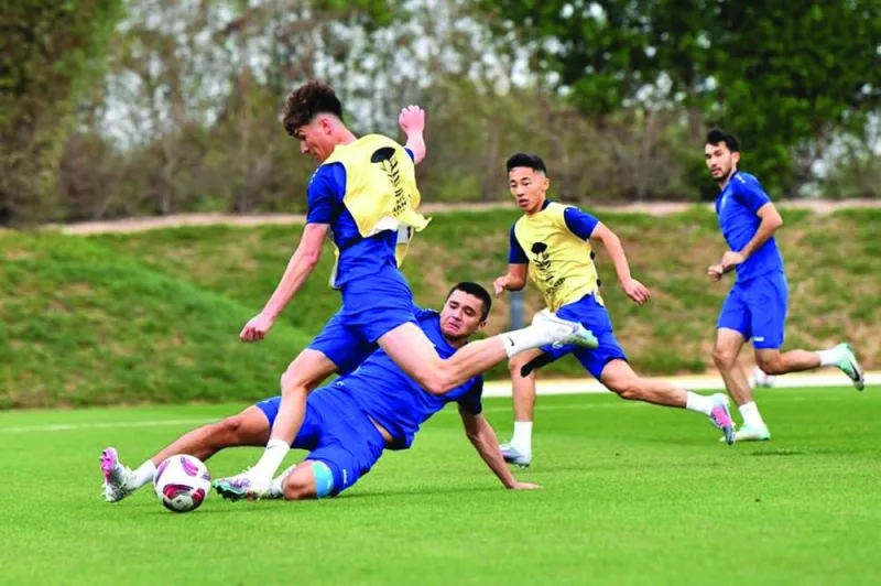 Uzbekistan players train in Doha on Monday, on the eve of their Asian Cup round of 16 match against Thailand.