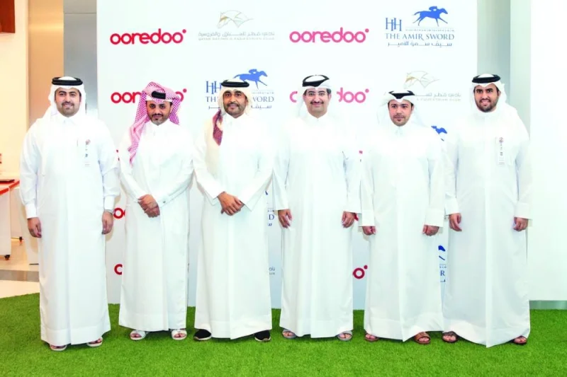 Sheikh Ali bin Jabor bin Mohamed al-Thani, CEO of Ooredoo Qatar and Issa bin Mohamed al-Mohannadi, Chairman of the Qatar Racing and Equestrian Club, pose with other officials after the press conference on Monday.
