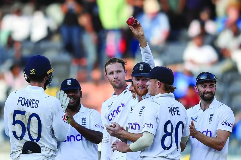 Mark Wood (right) claps as England’s Tom Hartley (third left) celebrates after taking a five-wicket haul during the fourth day of the first Test against India at the Rajiv Gandhi International Stadium in Hyderabad on Sunday. (AFP)