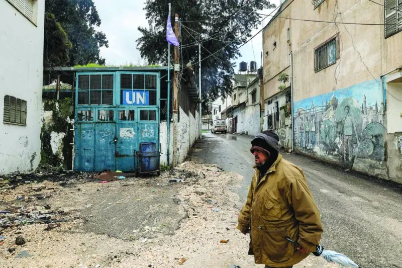
A man walks near a facility of the UN Relief and Works Agency for Palestine Refugees in the Near East (UNRWA) in the city of Jenin in the occupied West Bank, yesterday. 