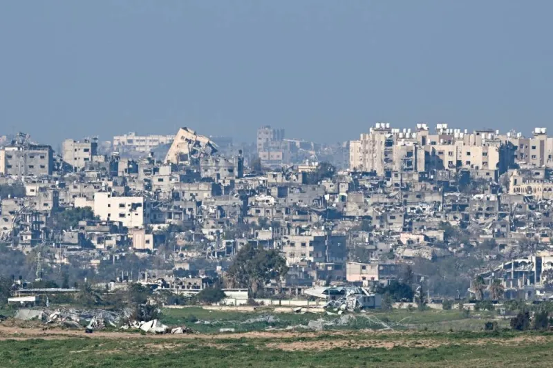 Damaged buildings stand amid the rubble in Gaza as seen from Sderot, Israel.