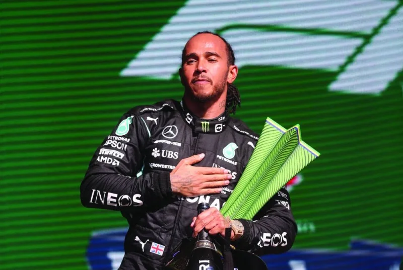 
Mercedes’ British driver Lewis Hamilton holds the trophy on the podium after winning Brazil’s Sao Paulo Grand Prix at the Autodromo Jose Carlos Pace, or Interlagos racetrack, in Sao Paulo, on November 14, 2021. (AFP) 