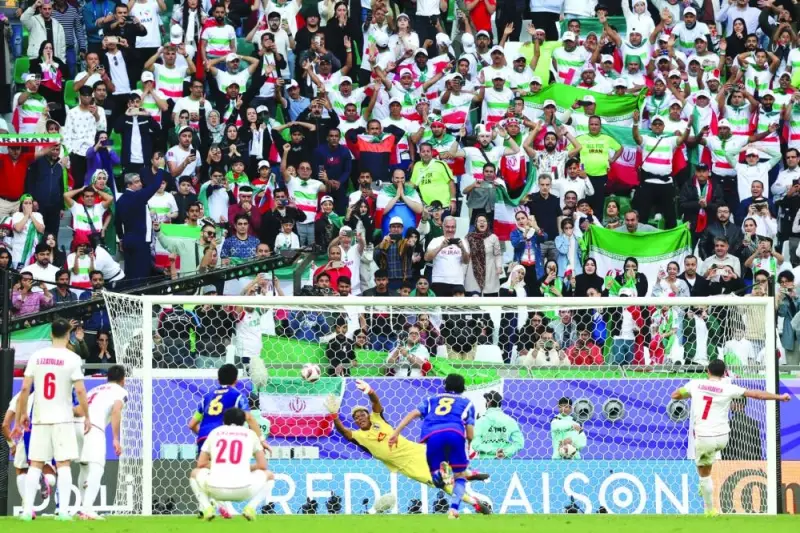 Iran’s Alireza Jahanbakhsh (right) scores a penalty in the stoppage time during the AFC Asian Cup quarter-final against Japan at Education City Stadium in Doha on Saturday. (AFP)