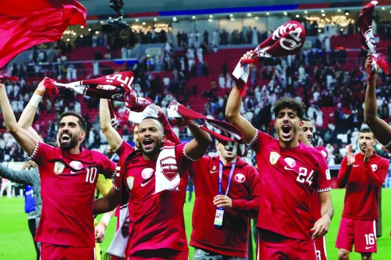 Qatar’s players celebrate after winning the AFC Asian Cup 2023 quarter-final against Uzbekistan at Al Bayt Stadium on Saturday. (AFP)